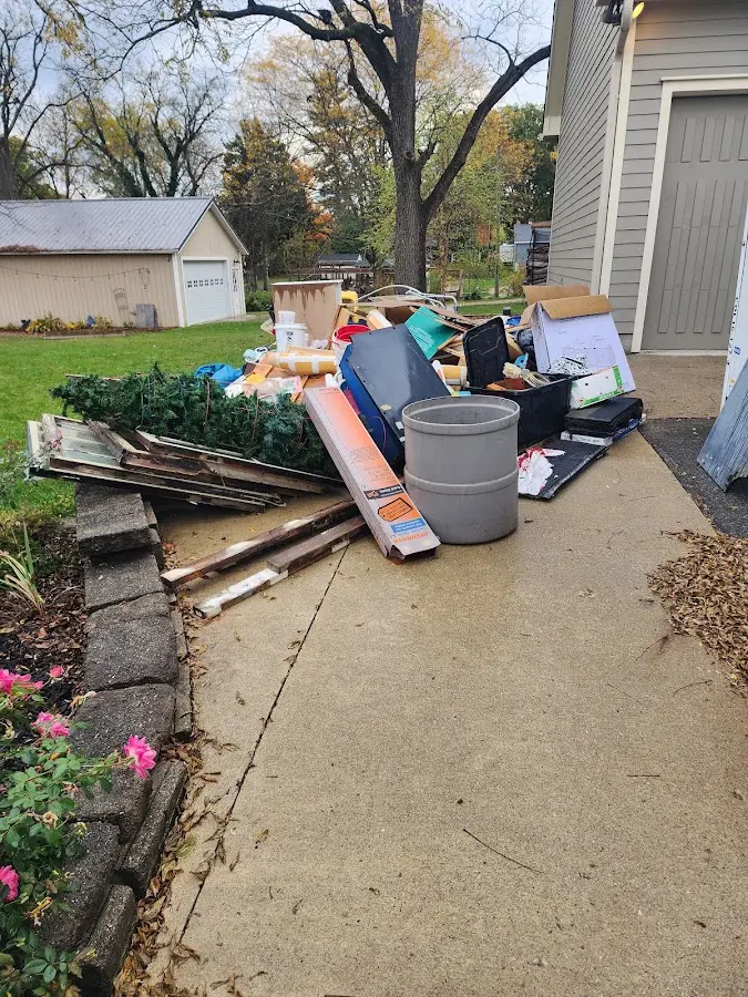 Dumpster being loaded with debris for 12 Yard Dumpster Rental in Wallingford